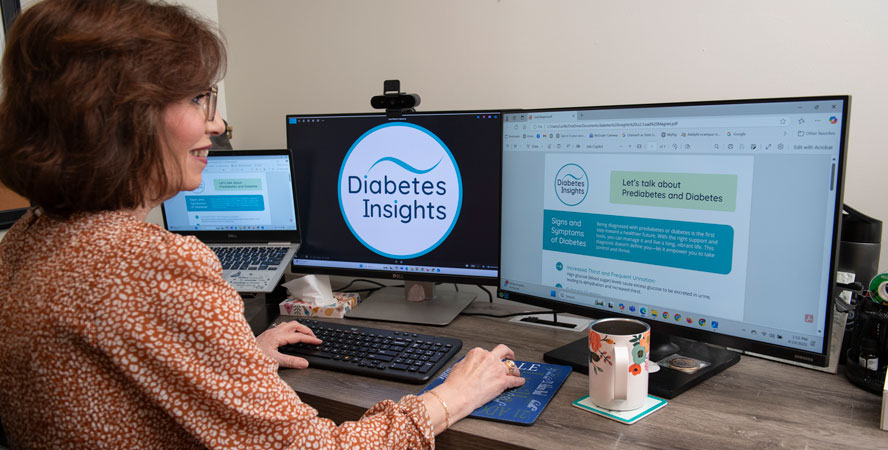 Lucille Hughes on her home office computers working on Diabetes Insights